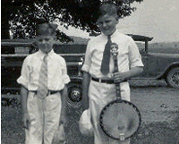 Young Sandy with his banjo and a friend